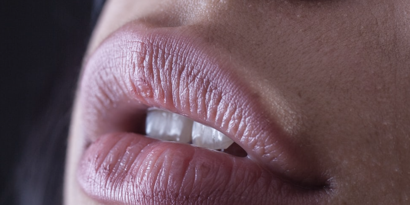 A close up of the lips and tongue of a woman.