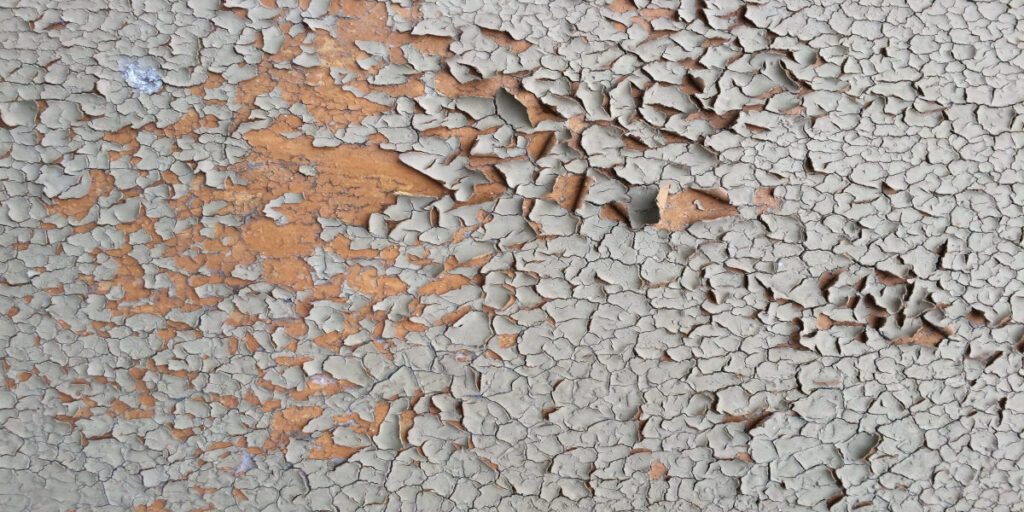 A close up of the cracked paint on the wall.