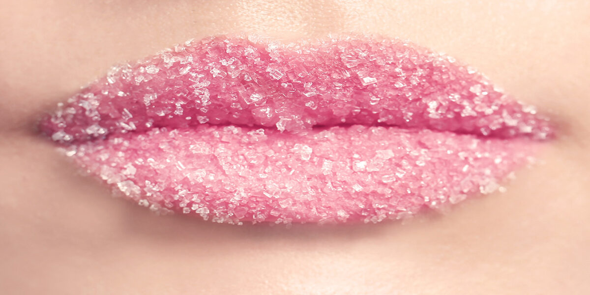 A close up of the lips with pink lipstick