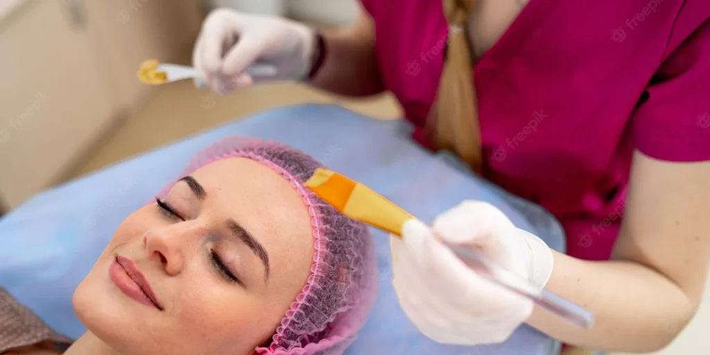 A woman getting her face waxed at the salon