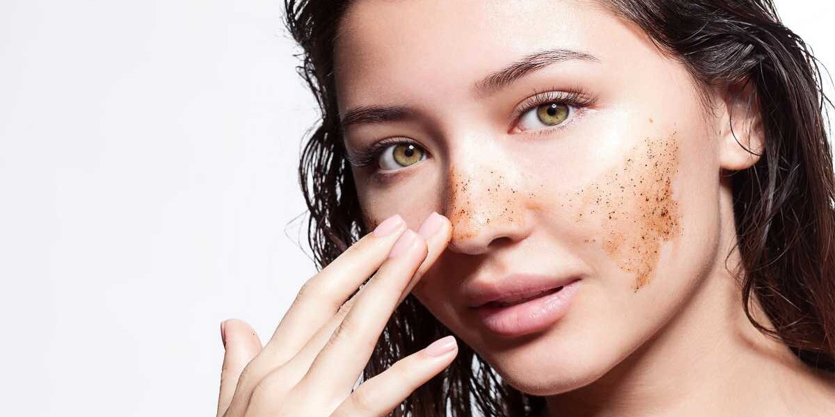 A woman with freckles touching her face.