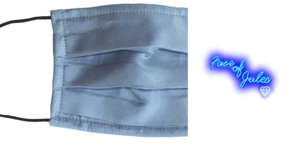 A blue face mask is shown with the light shining on it.