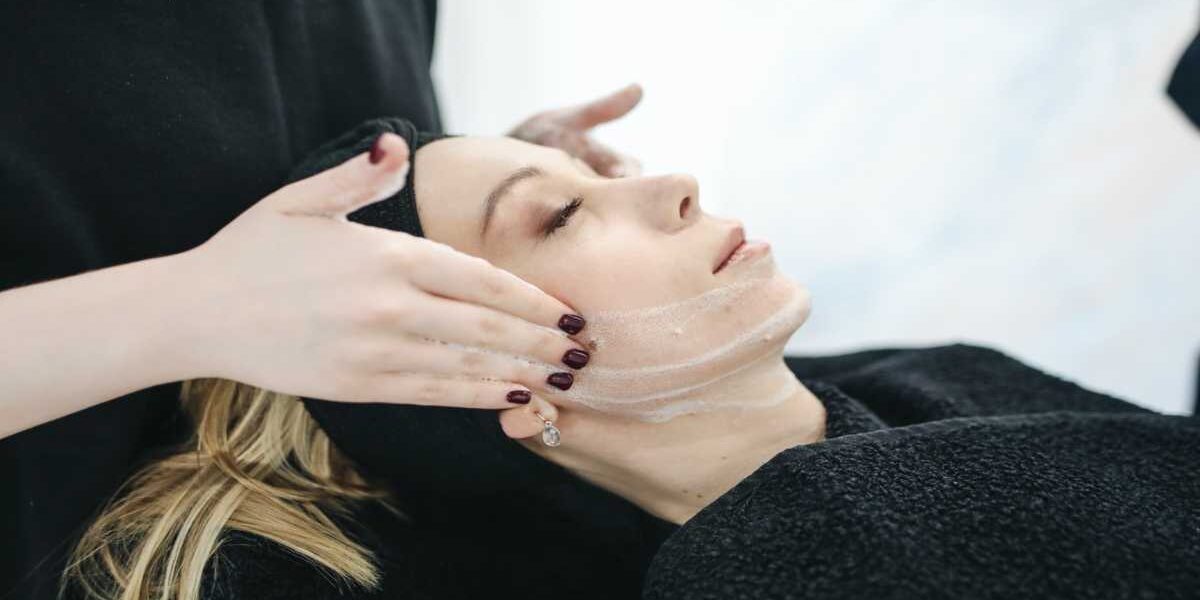 A woman is getting her face waxed