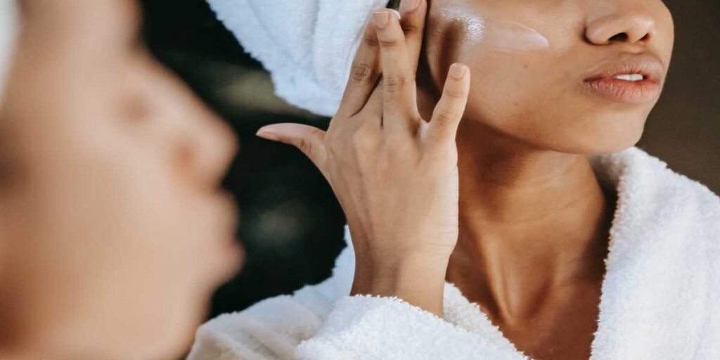 A person with their hand up to the side of his face.