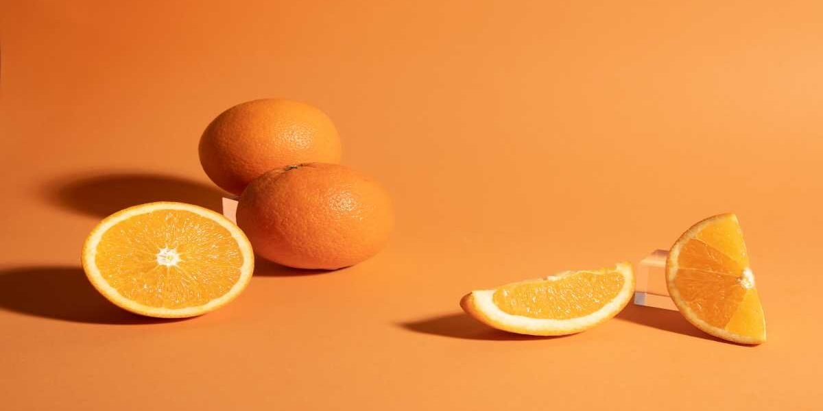 A close up of an orange and some other fruit