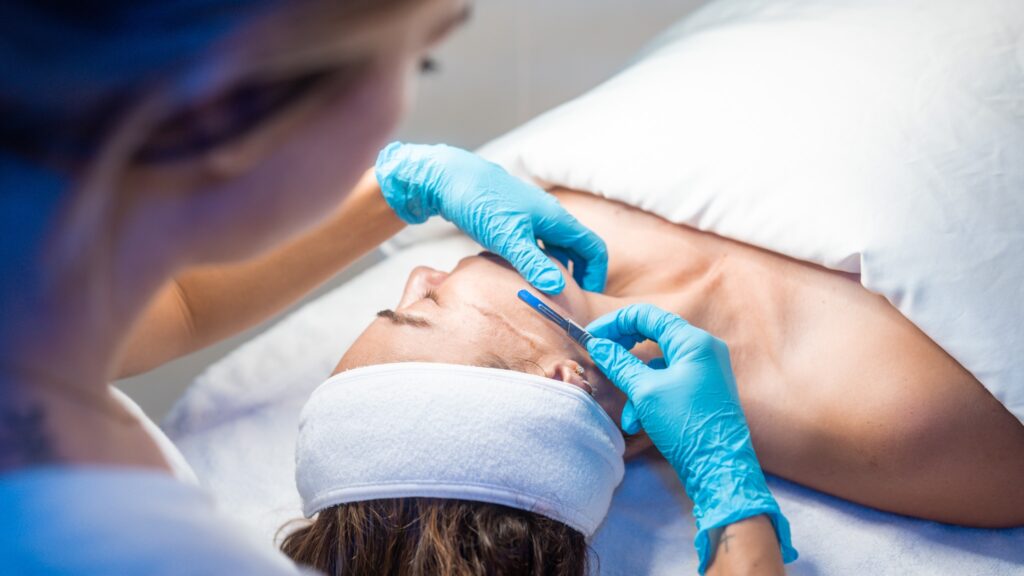 A person is getting their face waxed