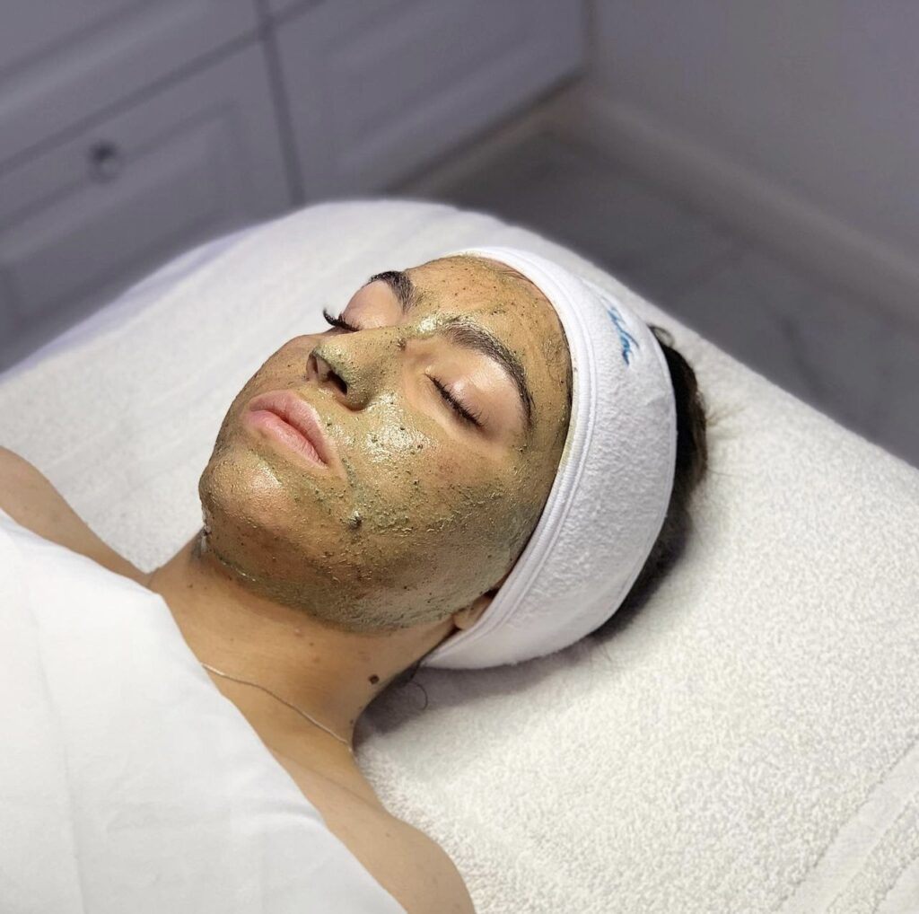 A woman with facial mask on laying down